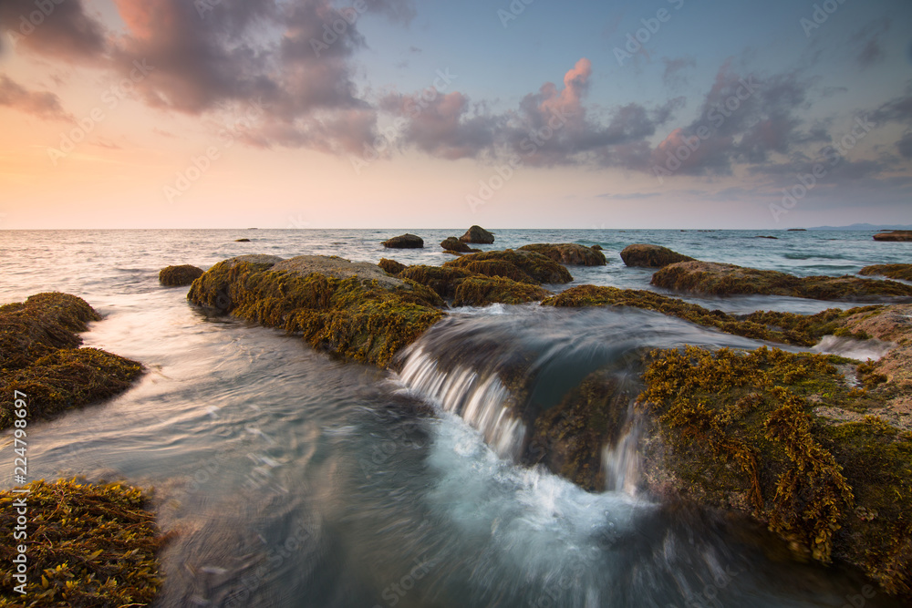 Sunset with mossy rocks at a beach in Kudat, Sabah, Borneo, East malaysia
