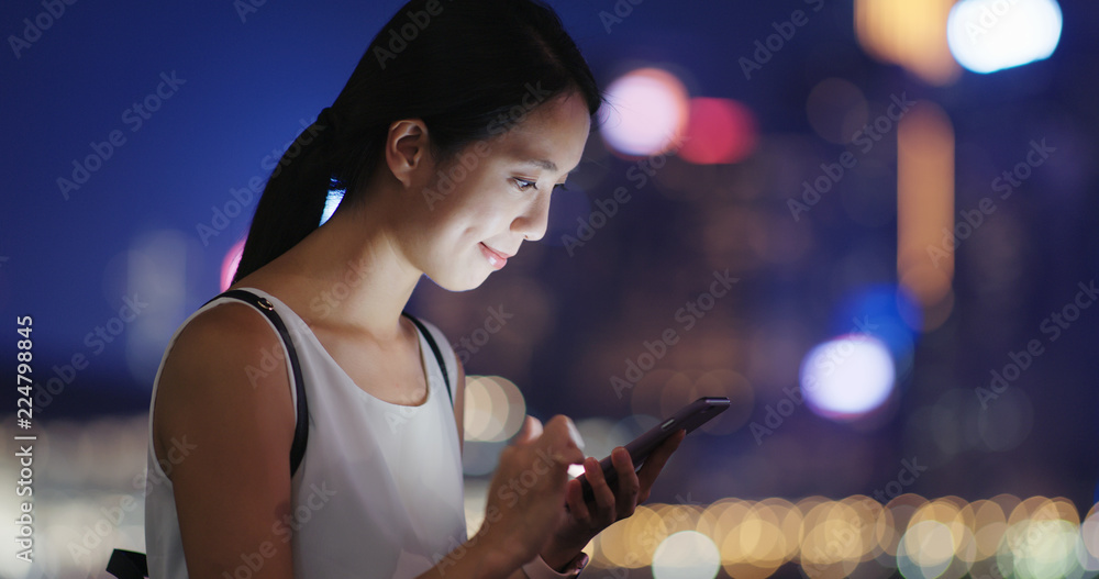 Woman use of mobile phone in city Woman use of mobile phone in city
