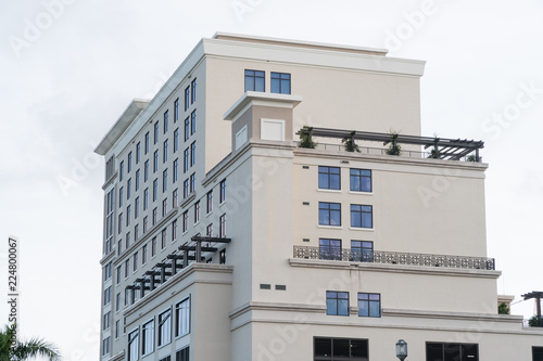 Obraz na płótnie Day time exterior establishing shot of generic apartment, hotel, or condo building in tropical vacation destination location during summer time weather. w salonie