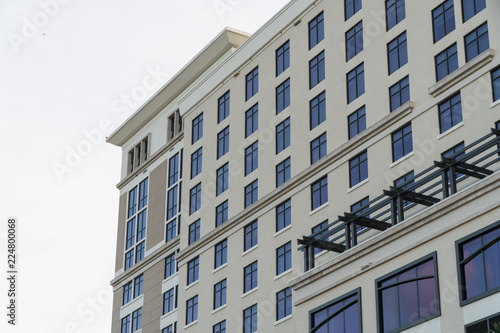 Exterior typical establishing shot stock photo of building facade during day time as apartment condo or hotel structure.