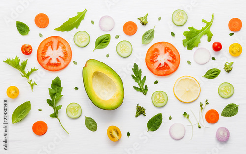 Food pattern with raw ingredients of salad on white wooden background.