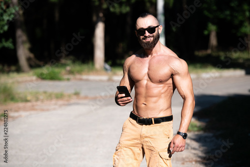 Beard Man Using Mobile Phone Outdoors in Park