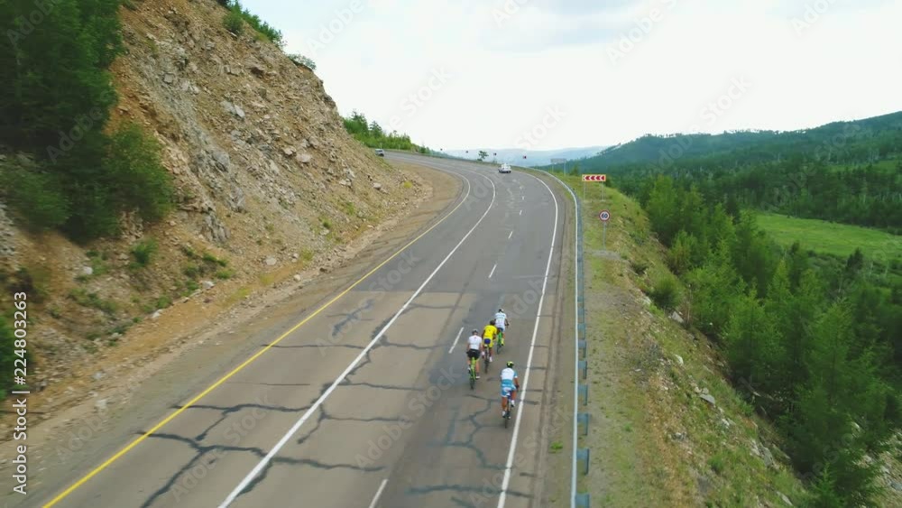 Aerial view of road cyclists and cars. Red Bull Trans-Siberian Extreme 4k Aerial view of road cyclists and cars. Red Bull Trans-Siberian Extreme 4k