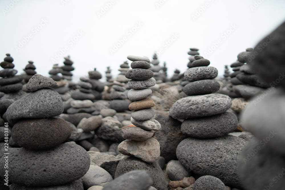 A pile of pebbles is built in the form of a pyramid. A pile of pebbles is built in the form of a pyramid.