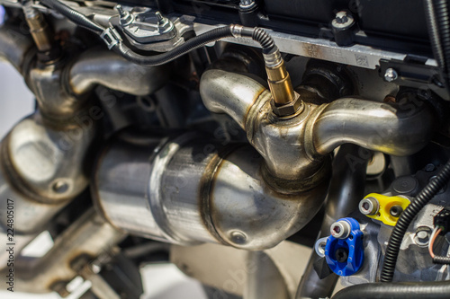 Close up of sport engine exhaust part with polished pipes photo