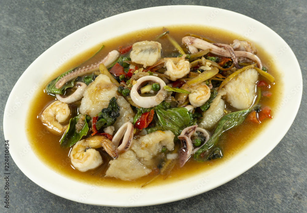 Fried stir spicy sea food on stone background. Top view. . Fried stir spicy sea food on stone background. Top view. .