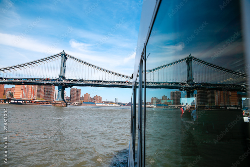 Naklejka premium reflection on ferry and brooklyn bridge