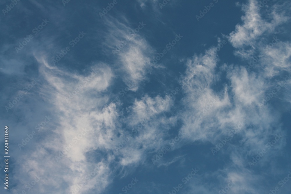 Blue sky with white wispy clouds