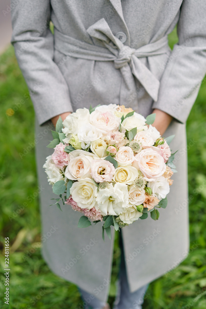 spring mood. Young girl holding a beautiful wedding bouquet. flower arrangement with white and Pastel color flowers. spring mood. Young girl holding a beautiful wedding bouquet. flower arrangement with white and Pastel color flowers.
