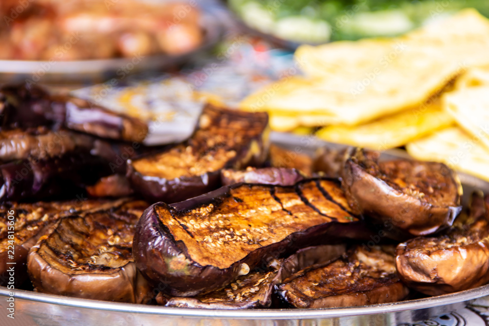 Delicious baked eggplants on the grill street food Delicious baked eggplants on the grill street food