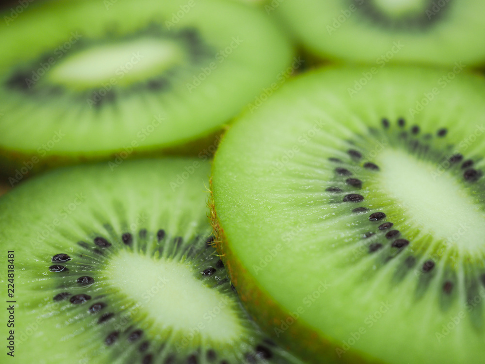 Slice of fresh juicy delicious and healthy kiwi fruit, close up Slice of fresh juicy delicious and healthy kiwi fruit, close up