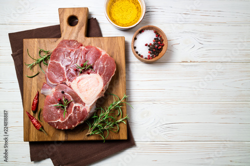Canvastavla Raw beef steak osso bucco with spices on white wooden table