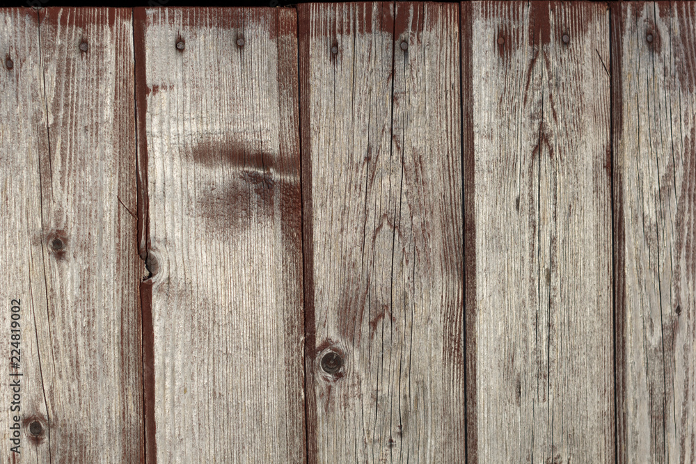 background old faded and cracked wooden boards of brown color faded from the sun background old faded and cracked wooden boards of brown color faded from the sun