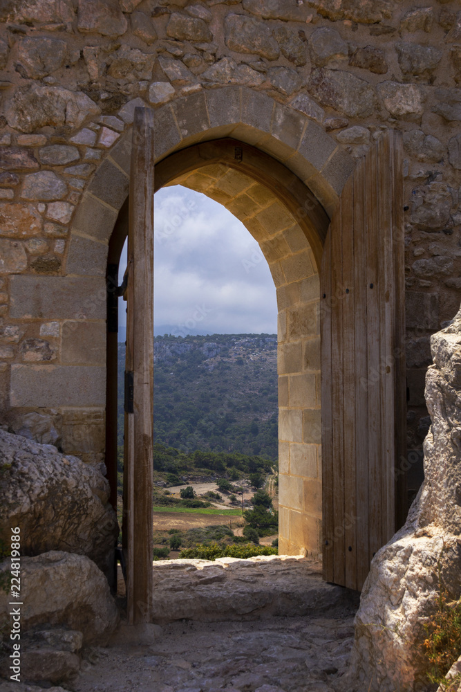 open door to the ancient fortress on the top of the hill through which beautiful views of the surrounding nature, mountains, forests, hills