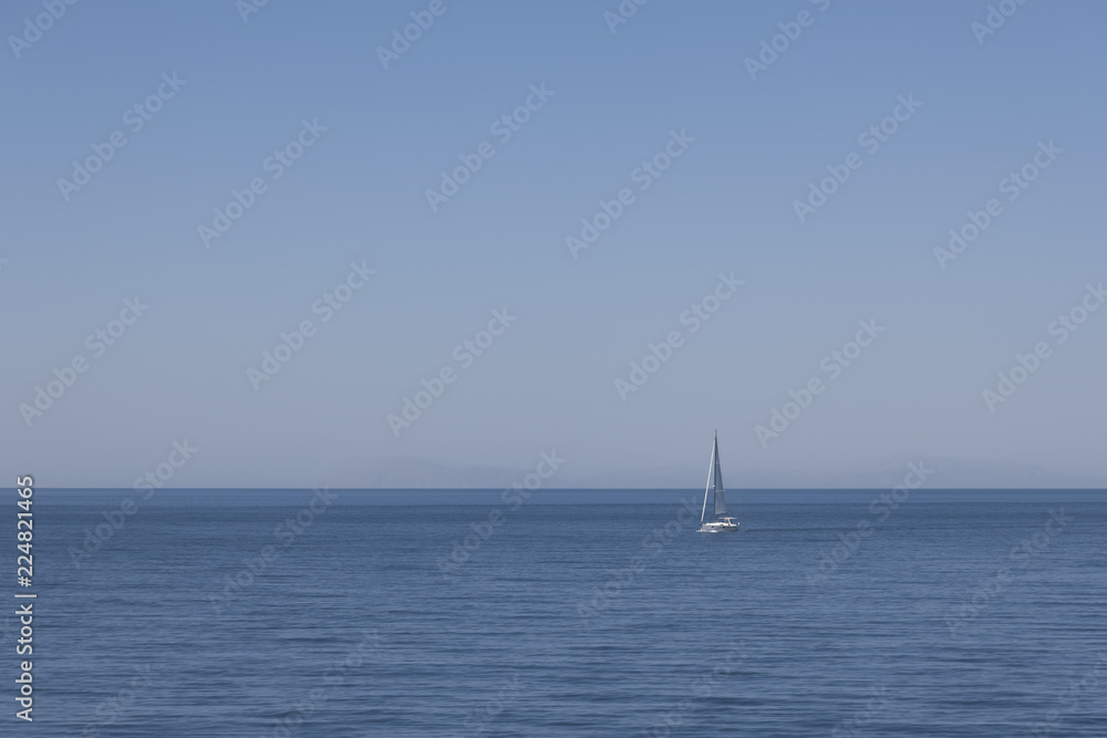 the background image of the sea and white boat and cliffs in the background