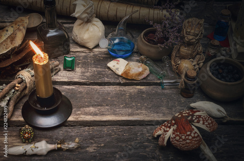 Wizard table with various magic accessories and ingredients. Witchcraft. Herbal alternative medicine.