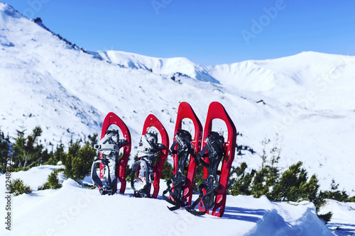 Winter trekking in the mountains. Snowshoes stand in the snow.