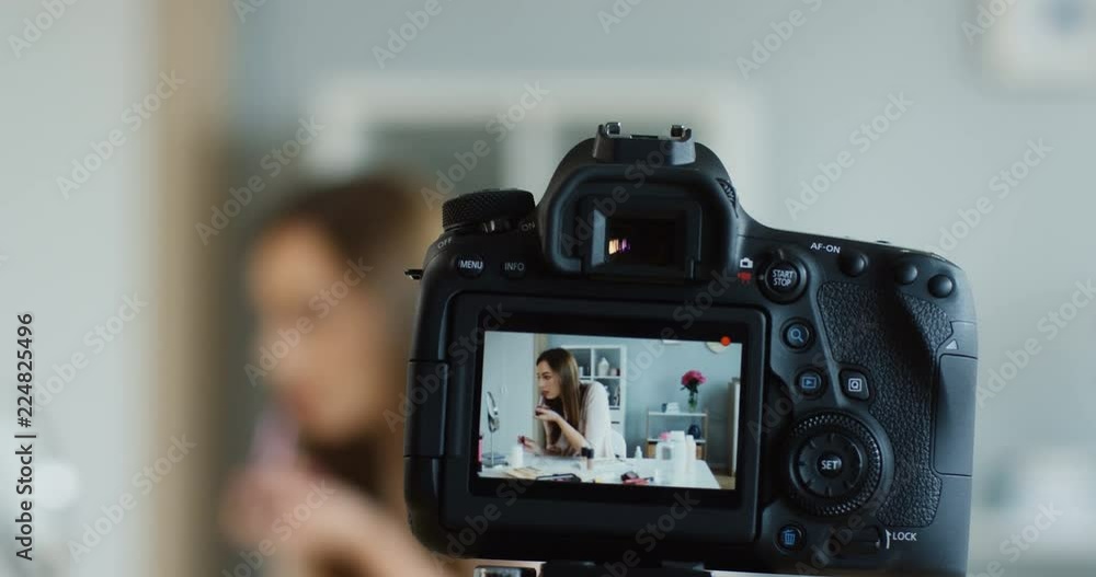 Close up of the camera screen on which young woman recording blog video while doing makeup and painting her lips. Close up of the camera screen on which young woman recording blog video while doing makeup and painting her lips.