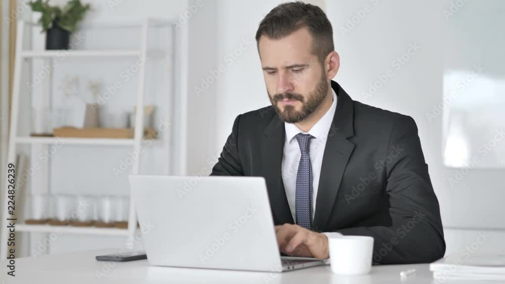 Pensive Businessman Thinking and Working on Laptop Pensive Businessman Thinking and Working on Laptop