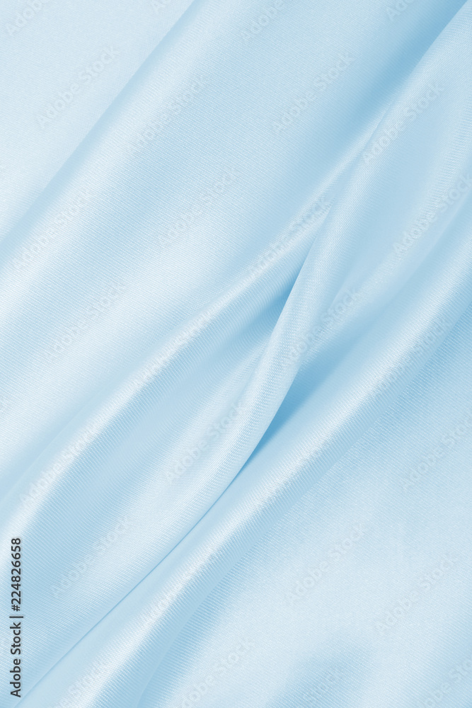 Smooth elegant blue silk or satin luxury cloth texture as abstract background. Luxurious background design Smooth elegant blue silk or satin luxury cloth texture as abstract background. Luxurious background design