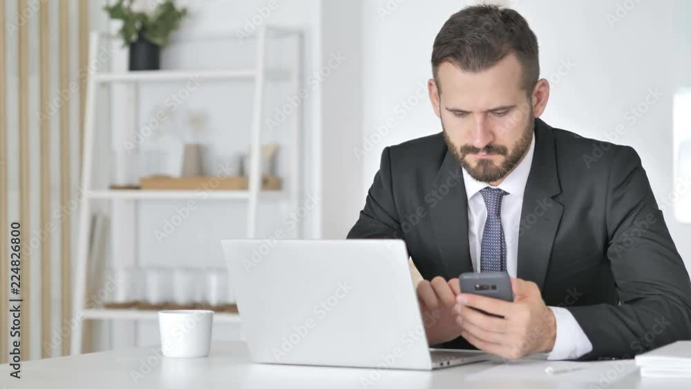 Businessman Using Smartphone for Online Financial Trading Businessman Using Smartphone for Online Financial Trading