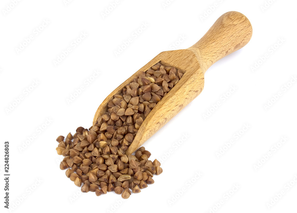 Buckwheat on wooden scoop isolated on white background Buckwheat on wooden scoop isolated on white background