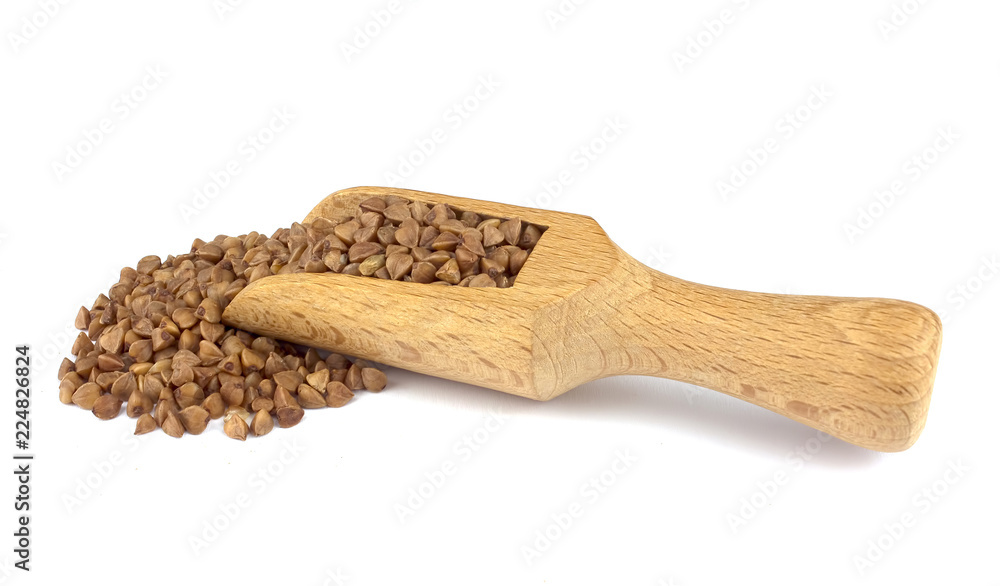 Buckwheat on wooden scoop isolated on white background Buckwheat on wooden scoop isolated on white background