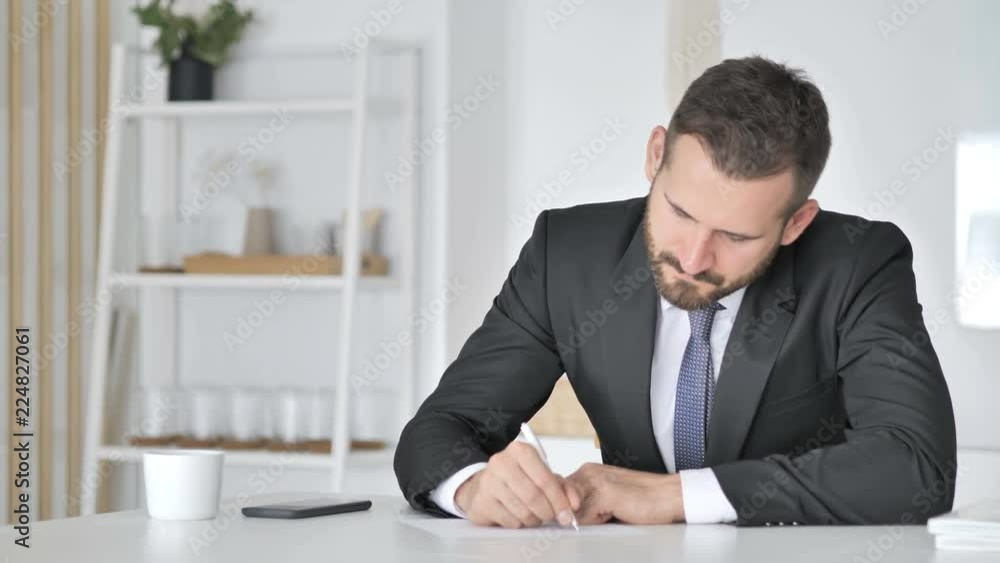 Businessman Writting Documents in Office Businessman Writting Documents in Office