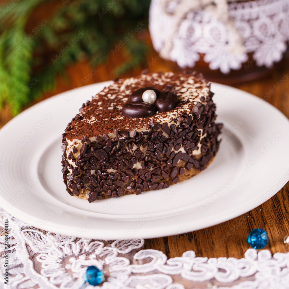 A piece of coffee cake with a white pearl A piece of coffee cake with a white pearl