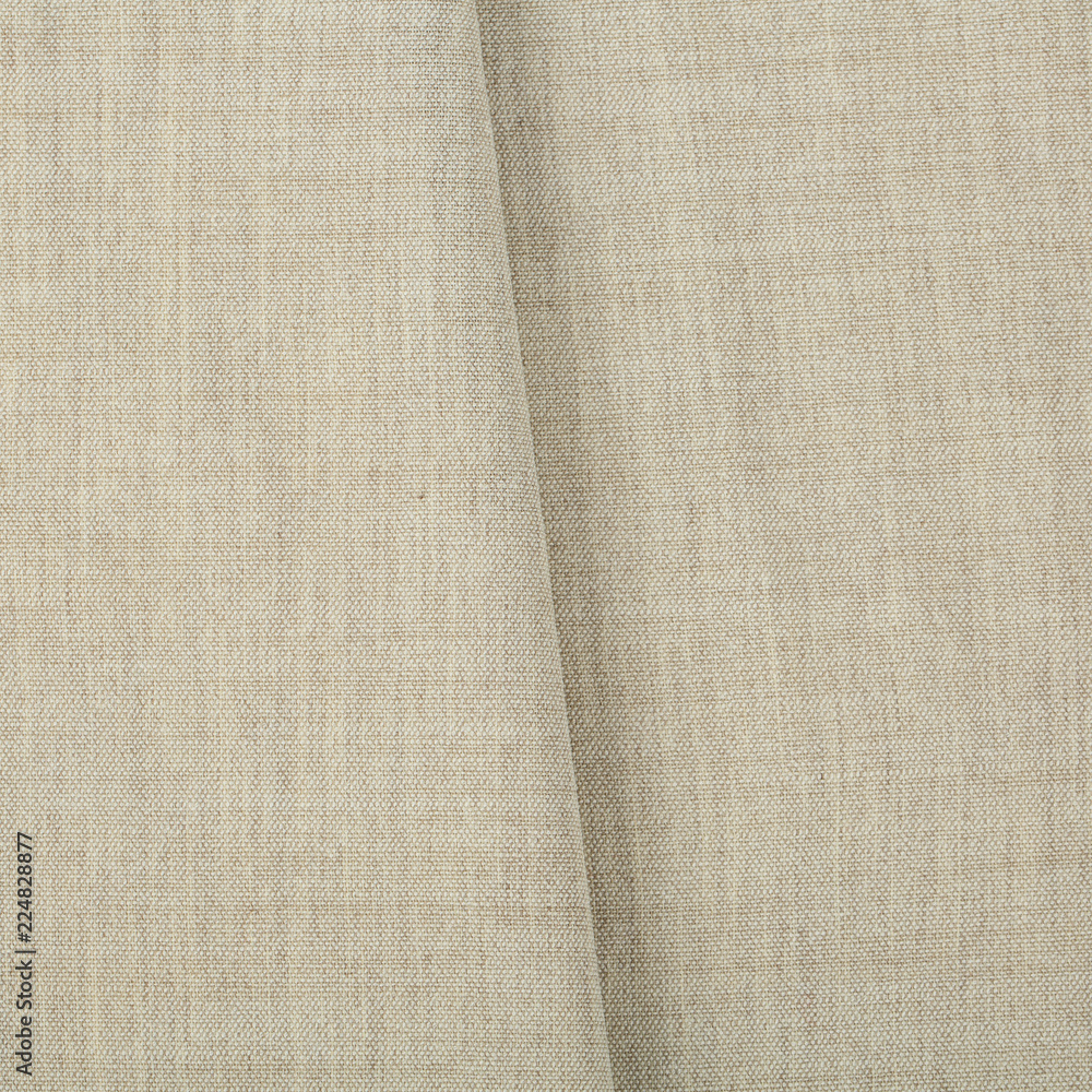 Fototapeta premium Soft linen fabric for sewing clothes. Texture canvas fabric as background. Texture fabric for feminine and men's shirts from flax.