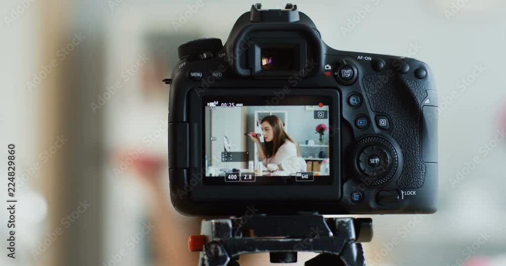 Close up of the camera screen on which young woman recording blog video while doing makeup for her cheeks. Close up of the camera screen on which young woman recording blog video while doing makeup for her cheeks.