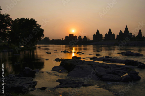 Sunset. silhouette of chatris on the bank of Betwa river at Orchha.Madhya Pradesh photo