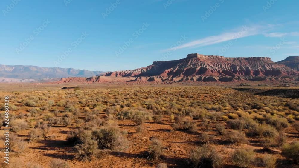Aerial low flying view of a Utah field with mountains in the distance Aerial low flying view of a Utah field with mountains in the distance