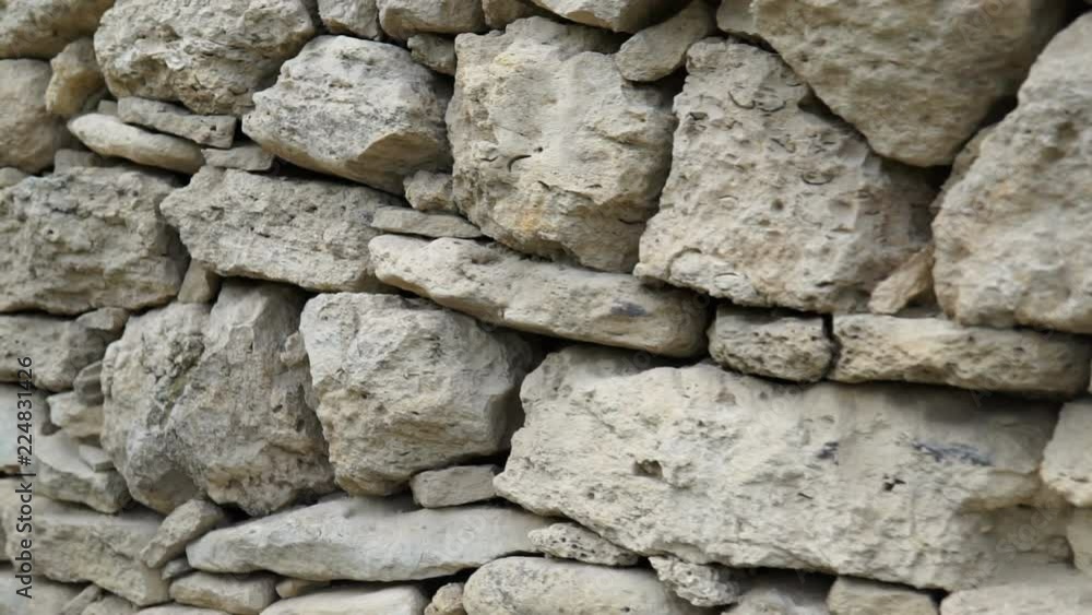 Texture of a stone wall. Old castle stone wall texture background. Stone wall as a background or texture. Camera moving. Texture of a stone wall. Old castle stone wall texture background. Stone wall as a background or texture. Camera moving.