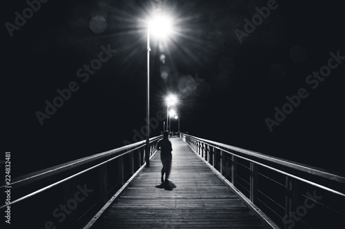 Anonymous woman walking on bridge
