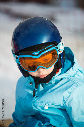 Girl in a helmet and ski glasses in the mountains © serkucher