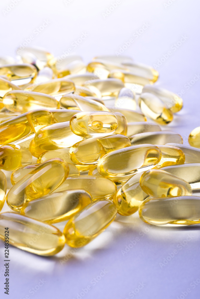 Capsules of fish fat oil on a white background with space for text Capsules of fish fat oil on a white background with space for text