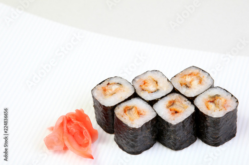 Rolls of Syak maki. Japanese food on a beautiful dish. Dietary food. An exquisite Japanese dish. Fresh dish of fish.