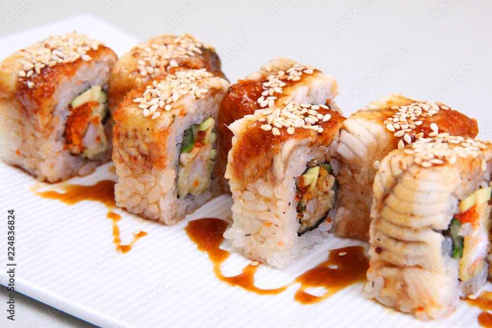 Roll Canada. Uromaki. Sushi in the nori. Japanese food on a beautiful dish. A delicious dish of japan. Roll Canada. Uromaki. Sushi in the nori. Japanese food on a beautiful dish. A delicious dish of japan.