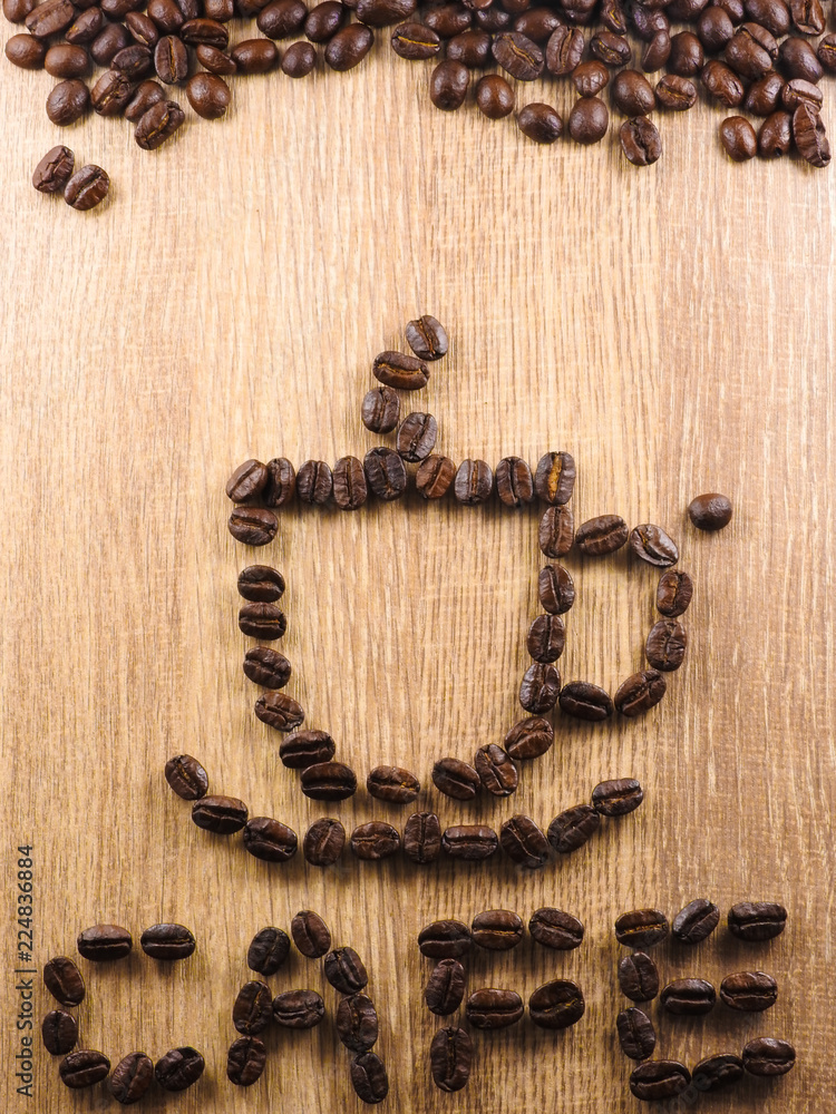 The coffee beans are arranged in a pattern of a cup of hot coffee, with the word The coffee beans are arranged in a pattern of a cup of hot coffee, with the word