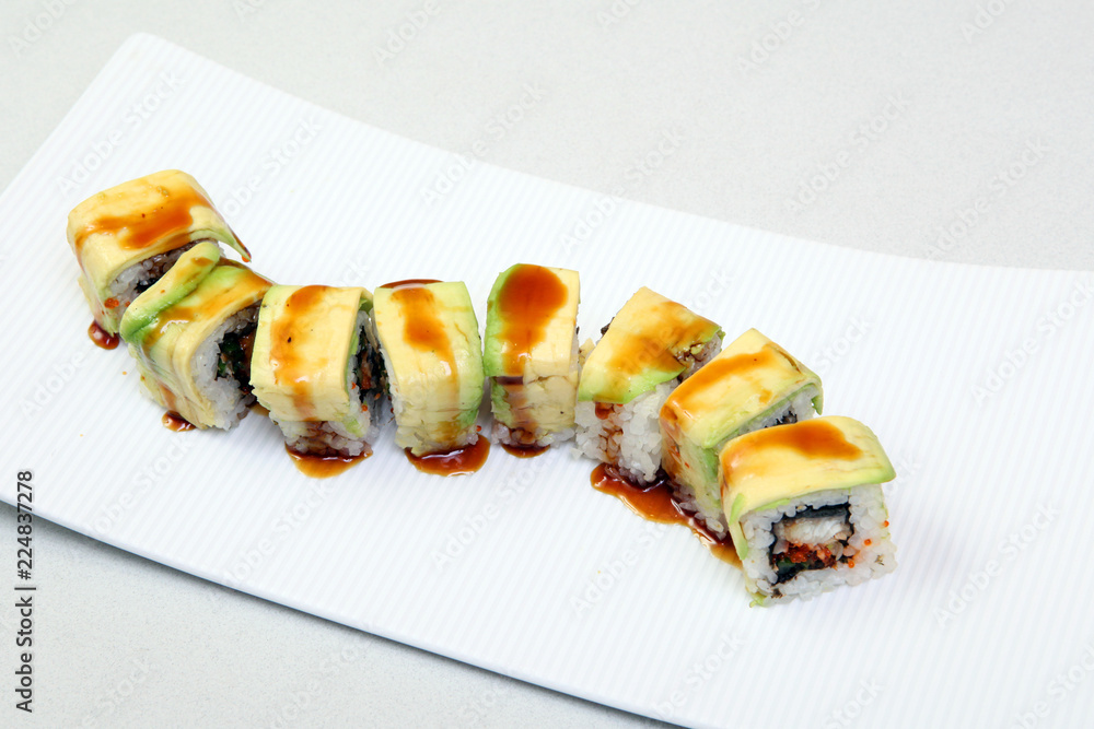 Roll with caviar of salmon. Sushi with caviar of flying fish. Japanese food on a beautiful dish. Roll with caviar of salmon. Sushi with caviar of flying fish. Japanese food on a beautiful dish.