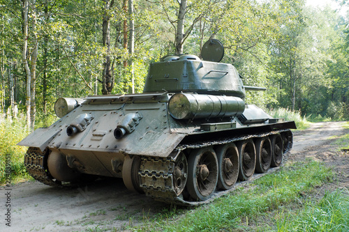 Russian rare tank of world war II in the forest going. The legendary retro shooting military tracked vehicles. photo