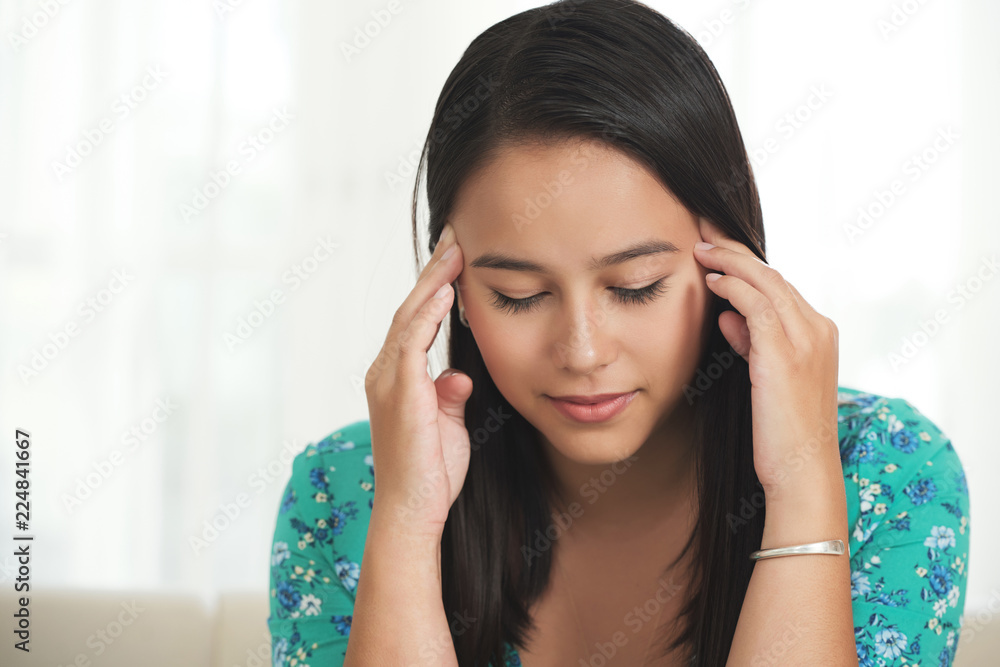 Young pretty woman suffering from severe migraine Young pretty woman suffering from severe migraine