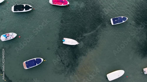 Aerial uplifting over colorful boats and yachts parking in La Manga del Mar Menor. Top aerial view of sail boats in open sea
