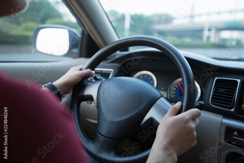 Commuting woman driving car on city road © lzf