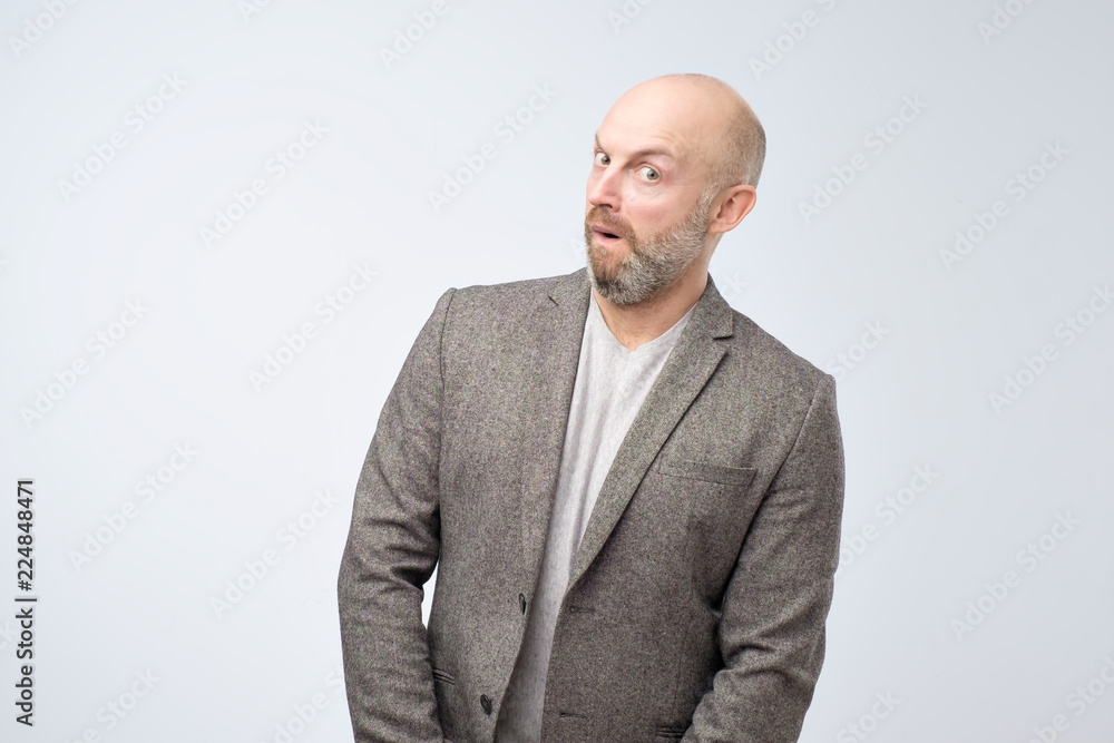 A mature man in casual suit looks interested in the camera. What are you hiding from me, show it. I am so excited concept A mature man in casual suit looks interested in the camera. What are you hiding from me, show it. I am so excited concept