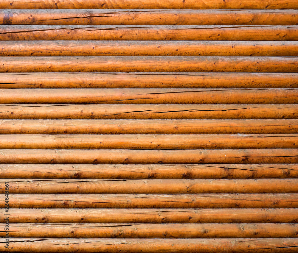 The texture of the old log on the house. Close-up. Wooden background. The texture of the old log on the house. Close-up. Wooden background.