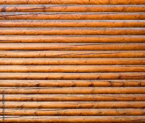 The texture of the old log on the house. Close-up. Wooden background.