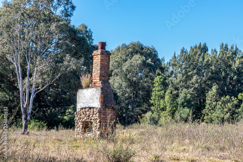 Old stone fireplace remains in paddock