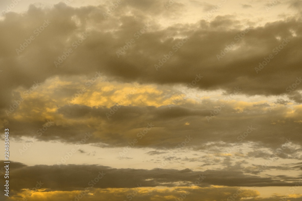 Fototapeta premium beautiful colorful orange sun colored clouds in the sky for using in design as background.